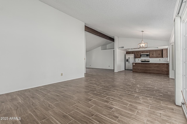 6701 W Monterey Way, Phoenix, AZ 85033 - unfurnished living room with dark wood-style flooring, a textured ceiling, and a sink
