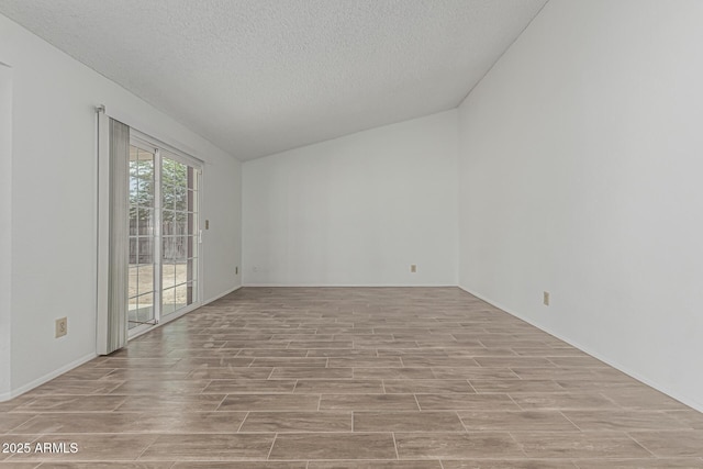 6701 W Monterey Way, Phoenix, AZ 85033 - spare room with light wood-type flooring, lofted ceiling, a textured ceiling, and baseboards