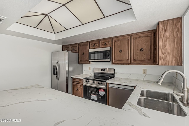 6701 W Monterey Way, Phoenix, AZ 85033 - kitchen featuring stainless steel appliances, a sink, and light stone counters