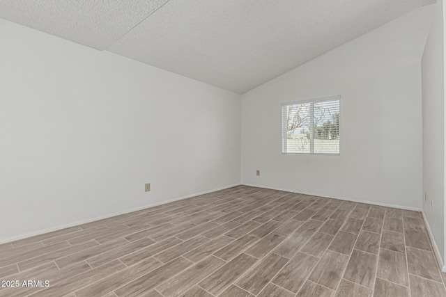 6701 W Monterey Way, Phoenix, AZ 85033 - empty room featuring light wood-style floors, lofted ceiling, baseboards, and a textured ceiling