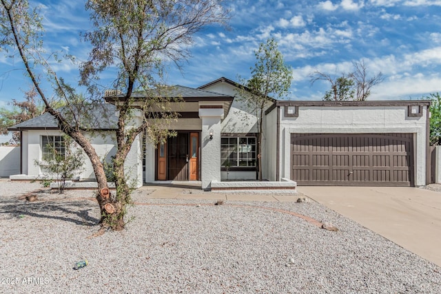 6701 W Monterey Way, Phoenix, AZ 85033 - view of front of property with an attached garage, concrete driveway, and stucco siding