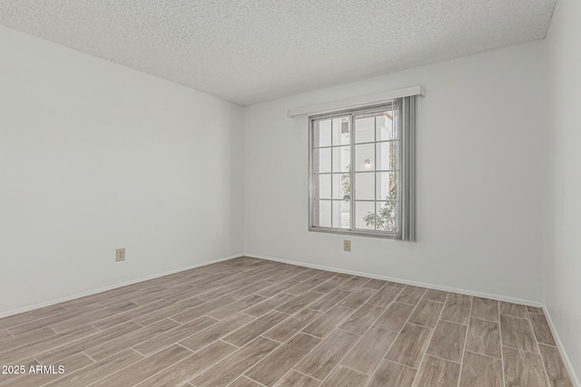 6701 W Monterey Way, Phoenix, AZ 85033 - unfurnished room featuring wood finished floors, a textured ceiling, and baseboards