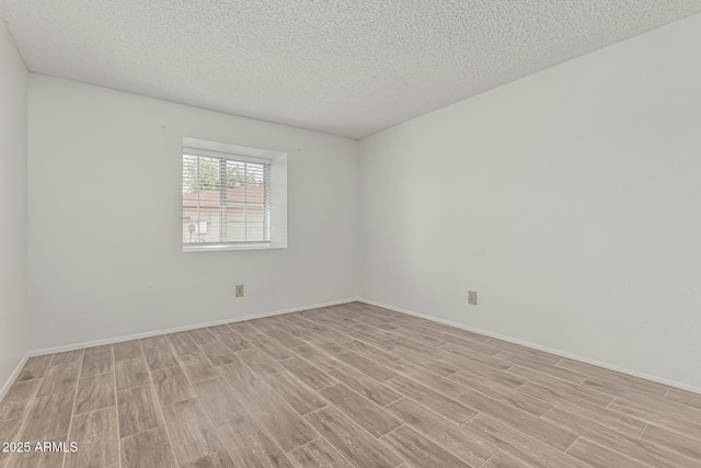 6701 W Monterey Way, Phoenix, AZ 85033 - unfurnished room with light wood finished floors, a textured ceiling, and baseboards