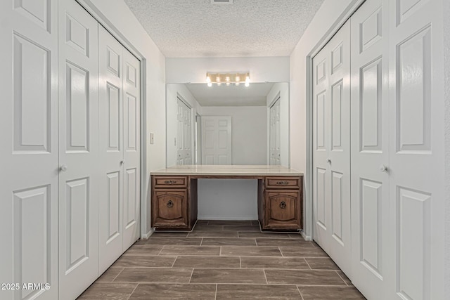 6701 W Monterey Way, Phoenix, AZ 85033 - bathroom with vanity, a textured ceiling, wood finish floors, and a closet