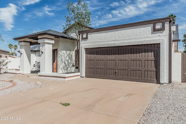 6701 W Monterey Way, Phoenix, AZ 85033 - view of front facade with stucco siding, a garage, and driveway