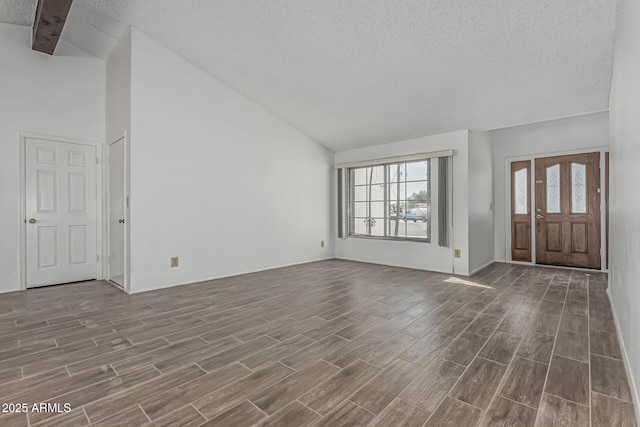 6701 W Monterey Way, Phoenix, AZ 85033 - foyer entrance featuring a textured ceiling, dark wood-style flooring, plenty of natural light, high vaulted ceiling, and baseboards