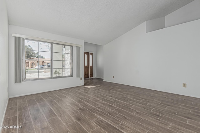 6701 W Monterey Way, Phoenix, AZ 85033 - spare room with a textured ceiling, dark wood-type flooring, and lofted ceiling