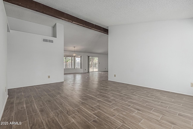 6701 W Monterey Way, Phoenix, AZ 85033 - empty room featuring a chandelier, wood finished floors, a textured ceiling, and baseboards