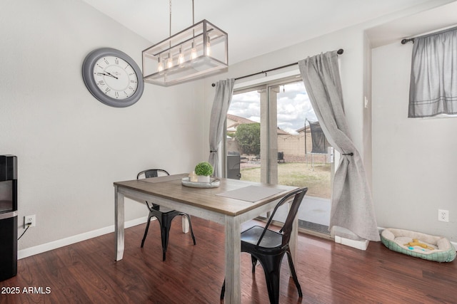 dining area featuring wood finished floors and baseboards