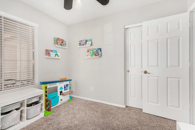 recreation room featuring ceiling fan, baseboards, and carpet