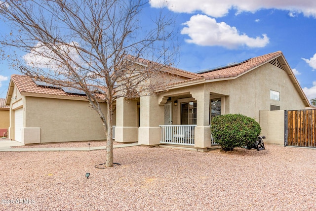 exterior space with stucco siding, a porch, and a tile roof