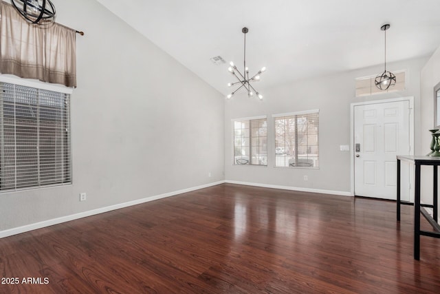 entrance foyer with visible vents, an inviting chandelier, and dark wood-style flooring