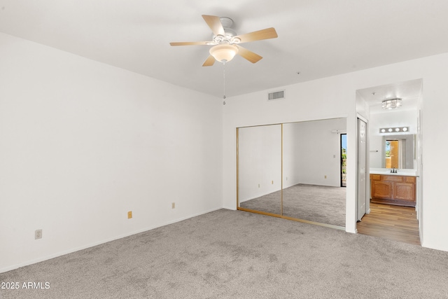 19400 N Westbrook Pkwy Unit 220, Peoria, AZ 85382 - unfurnished bedroom with carpet flooring, a closet, ensuite bathroom, and a ceiling fan