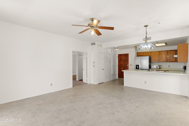 19400 N Westbrook Pkwy Unit 220, Peoria, AZ 85382 - kitchen with stainless steel fridge with ice dispenser, ceiling fan, brown cabinets, a peninsula, and light countertops
