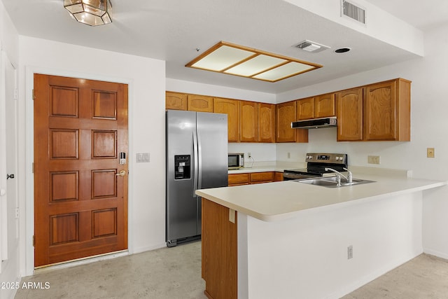 19400 N Westbrook Pkwy Unit 220, Peoria, AZ 85382 - kitchen featuring stainless steel appliances, extractor fan, a peninsula, brown cabinets, and light countertops