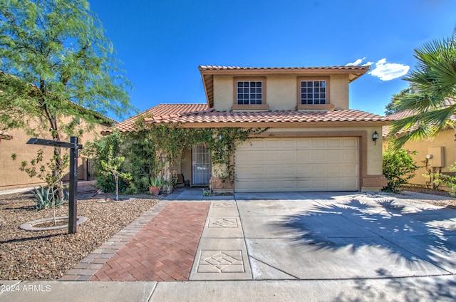 mediterranean / spanish house featuring a garage