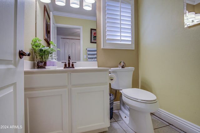 bathroom with toilet, crown molding, vanity, and tile patterned floors