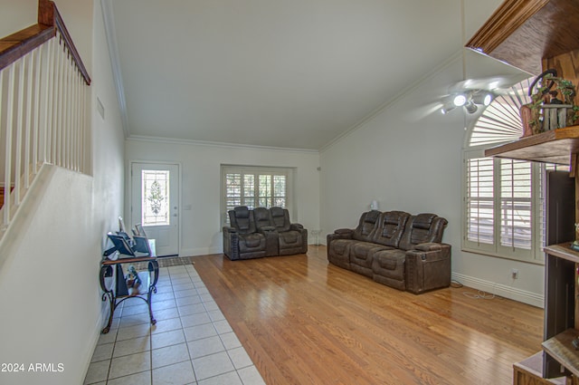 living room with crown molding and light wood-type flooring