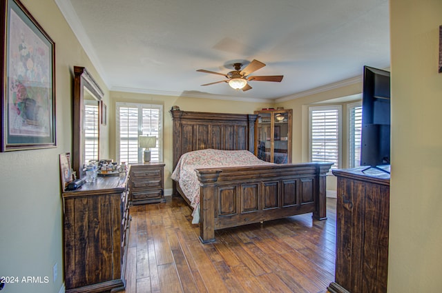 bedroom featuring ornamental molding, multiple windows, dark hardwood / wood-style floors, and ceiling fan