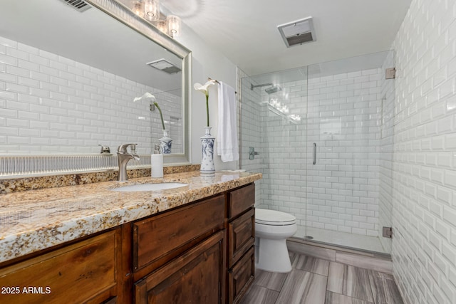 bathroom with vanity, toilet, and walk in shower