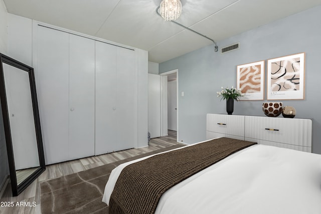 bedroom featuring light hardwood / wood-style floors and a closet