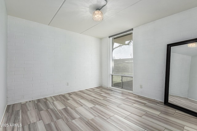 unfurnished room with brick wall