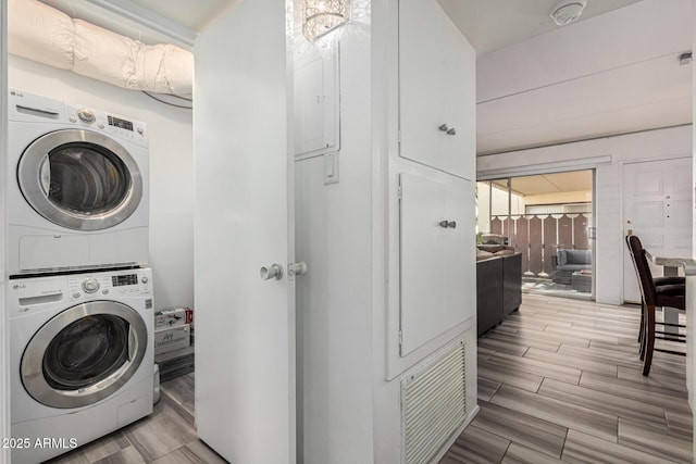 washroom featuring stacked washer and dryer