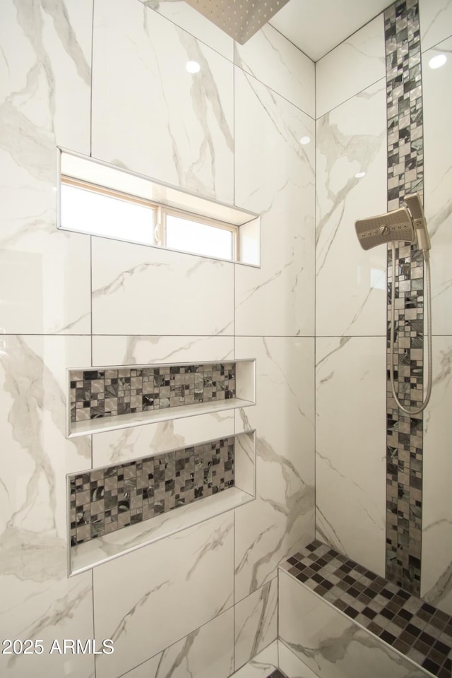 bathroom with tiled shower