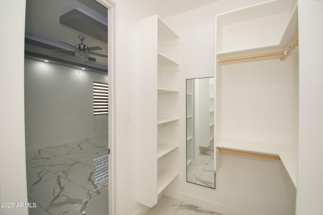 walk in closet featuring ceiling fan