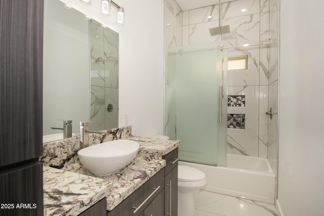 full bathroom featuring vanity, toilet, and shower / bath combination with glass door