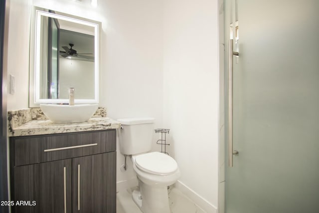 bathroom featuring vanity, ceiling fan, and toilet