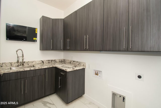 clothes washing area with cabinets, washer hookup, hookup for an electric dryer, and sink