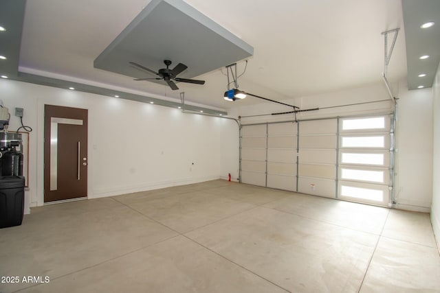 garage with ceiling fan and a garage door opener