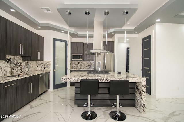 kitchen with a kitchen bar, backsplash, pendant lighting, and appliances with stainless steel finishes