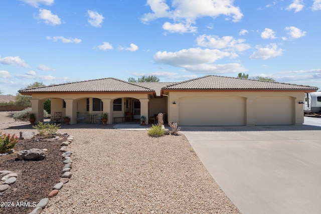 mediterranean / spanish-style home with a garage