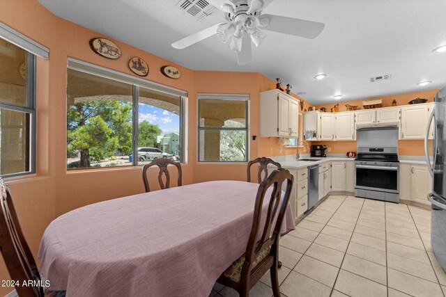 tiled dining area featuring a wealth of natural light, sink, and ceiling fan