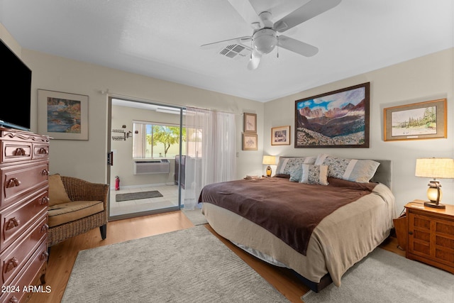 bedroom featuring cooling unit, ceiling fan, and hardwood / wood-style flooring