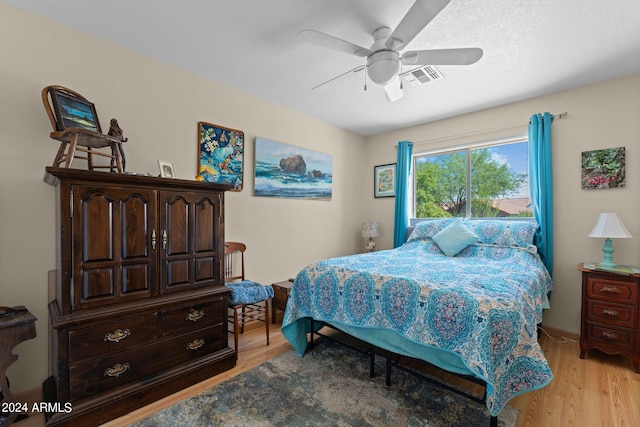 bedroom featuring ceiling fan and light hardwood / wood-style floors