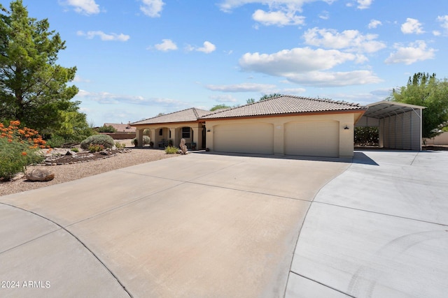 mediterranean / spanish house with a garage and a carport