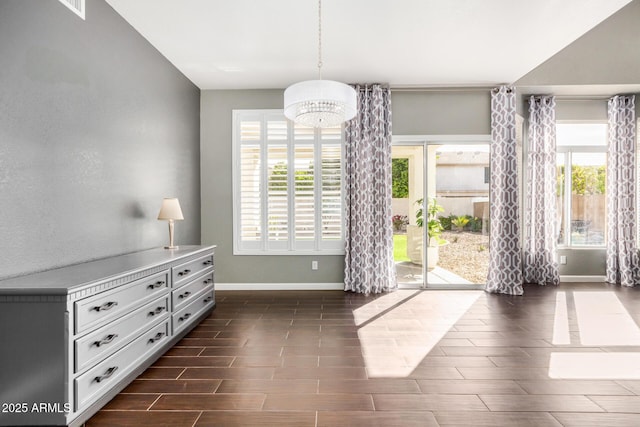 foyer entrance with plenty of natural light, baseboards, and wood finish floors