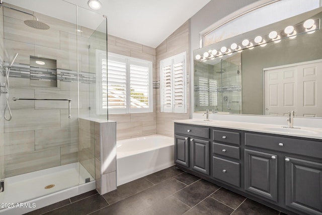 full bathroom featuring double vanity, a stall shower, a garden tub, and a sink