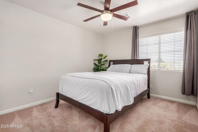 carpeted bedroom with a ceiling fan, baseboards, and visible vents