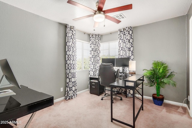 carpeted office with visible vents, baseboards, and ceiling fan