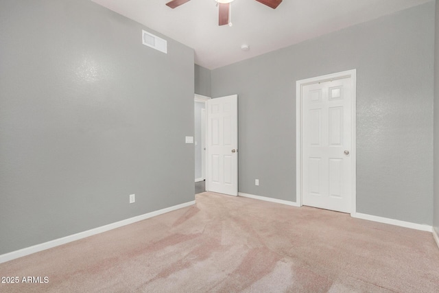 unfurnished bedroom featuring a ceiling fan, baseboards, visible vents, and carpet floors