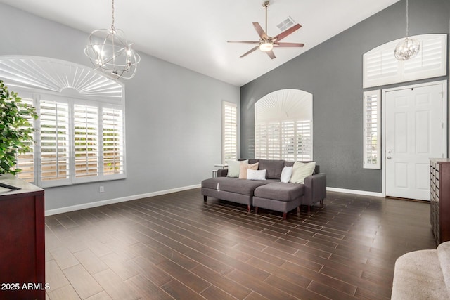 living area with visible vents, baseboards, dark wood-style floors, and ceiling fan with notable chandelier