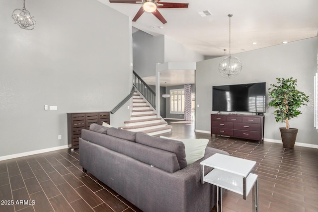 living room with visible vents, baseboards, wood tiled floor, and stairs