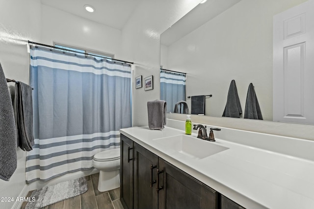 bathroom with vanity, toilet, and walk in shower