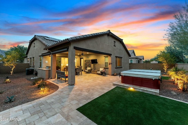 rear view of house featuring outdoor lounge area, ceiling fan, central AC unit, a patio, and a hot tub