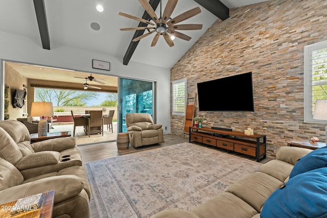 living room with beamed ceiling, hardwood / wood-style floors, and plenty of natural light