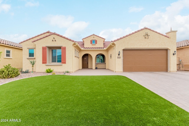 mediterranean / spanish-style house with a front lawn and a garage